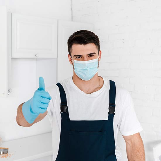 Pest control technician giving a thumbs up