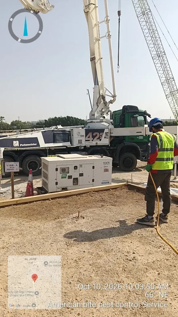 Technician applying anti-termite treatment to the plinth area of a new building in Al Jurf, Abu Dhabi