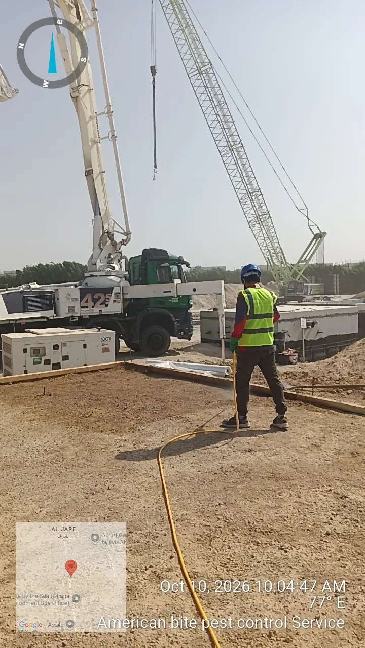 American Bite technician spraying termiticide on compacted soil before concrete work at a construction site in Abu Dhabi